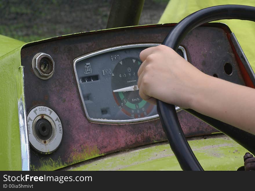 Boy holding a tractor wheel.