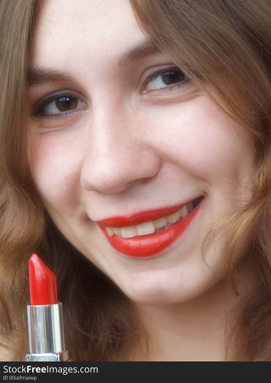 Smiling beautiful girl with lipstick