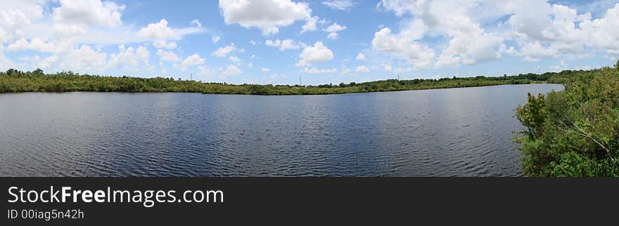 This is a panoramic of sawgrass lake and the sky and clouds. This is a panoramic of sawgrass lake and the sky and clouds