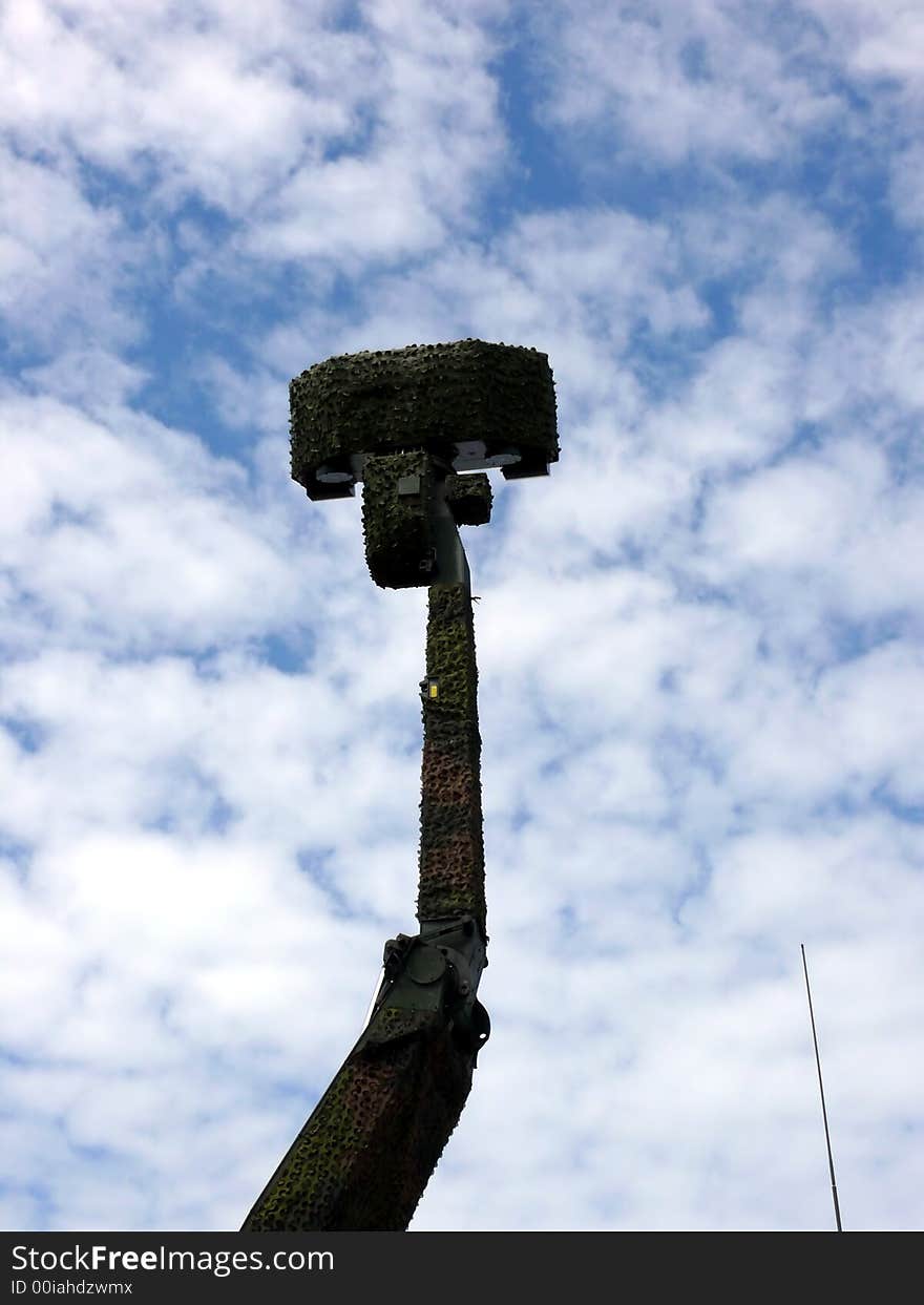 Portrait of military radar in blue sky