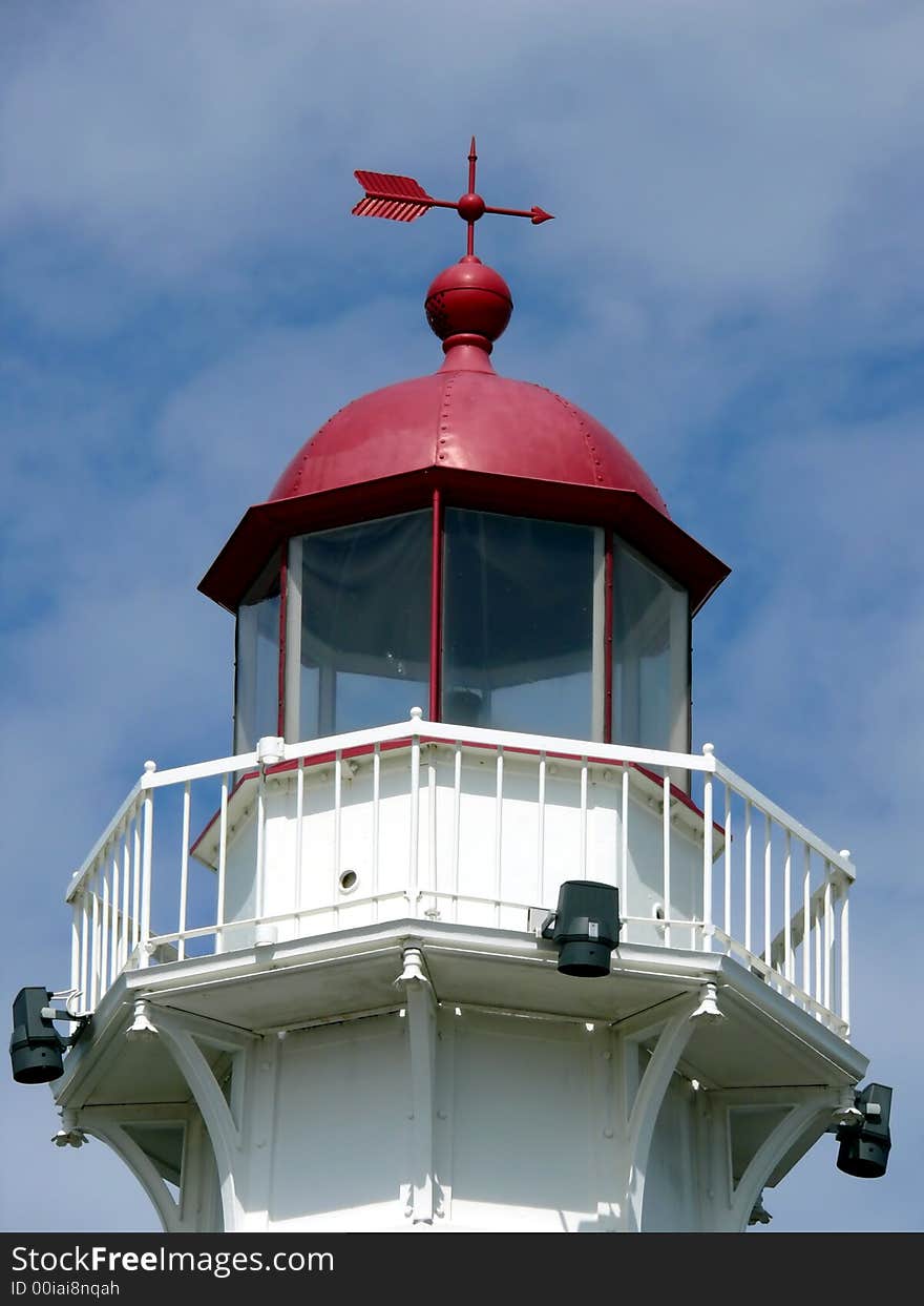 Closeup portrait of lighthouse in blue sky