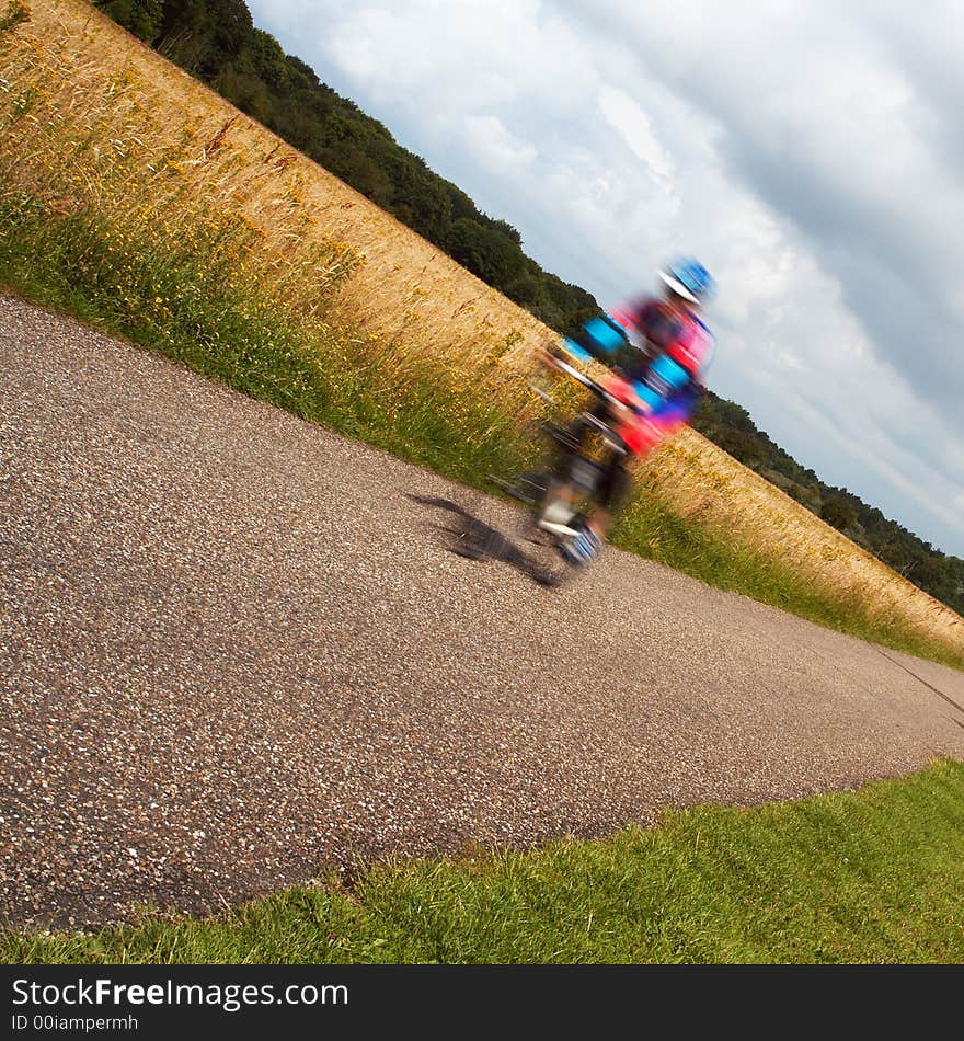 A race cycle (with motion blur) racing though the fields. A race cycle (with motion blur) racing though the fields.