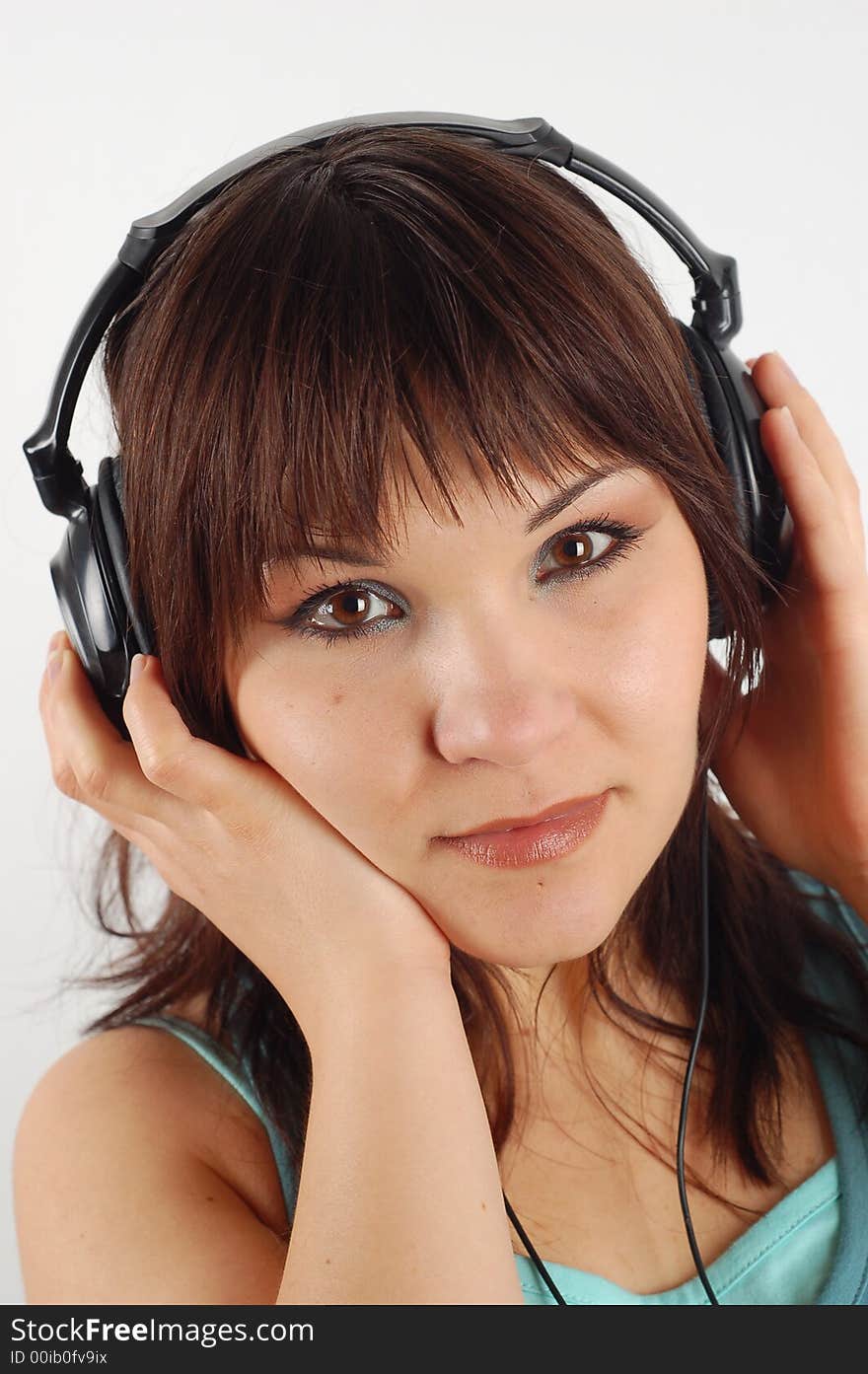 Attractive brunette woman with headphones isolated on white background. Attractive brunette woman with headphones isolated on white background