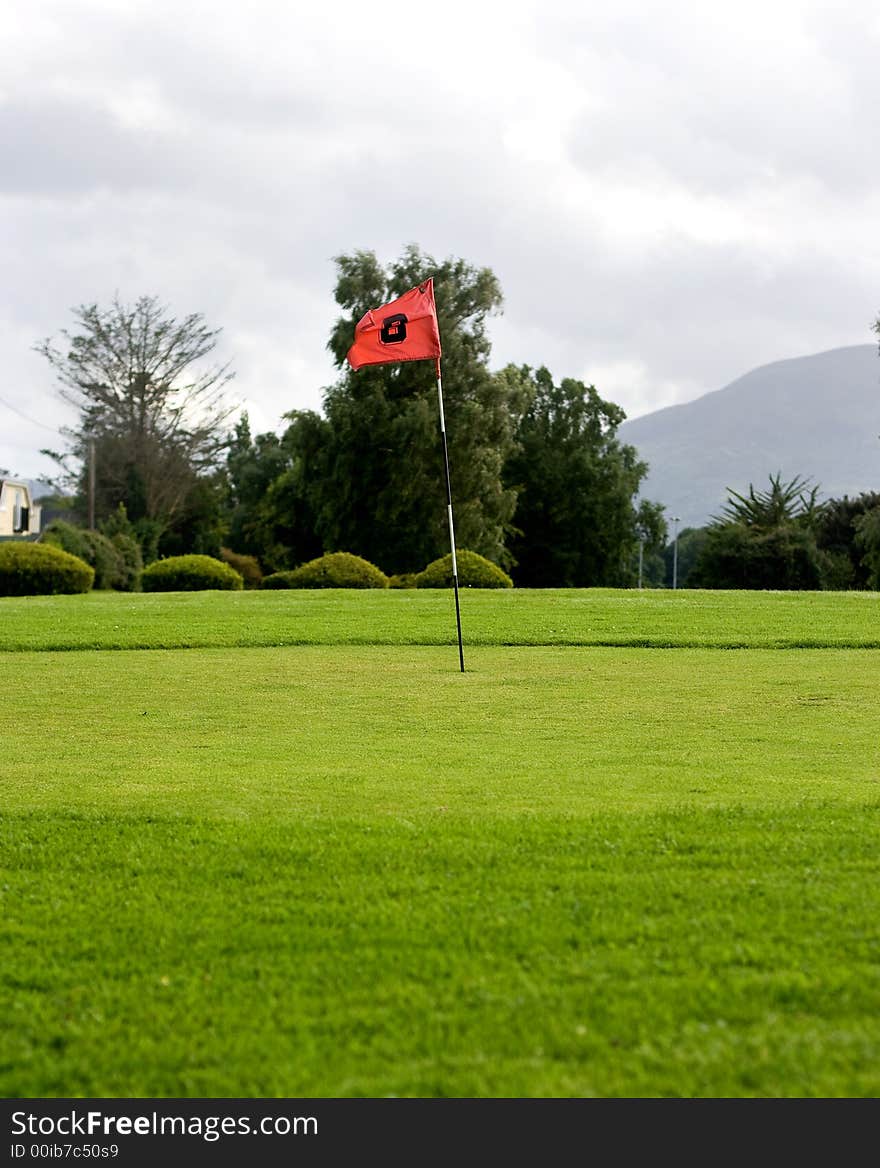 Golf field with red flag. Golf field with red flag.