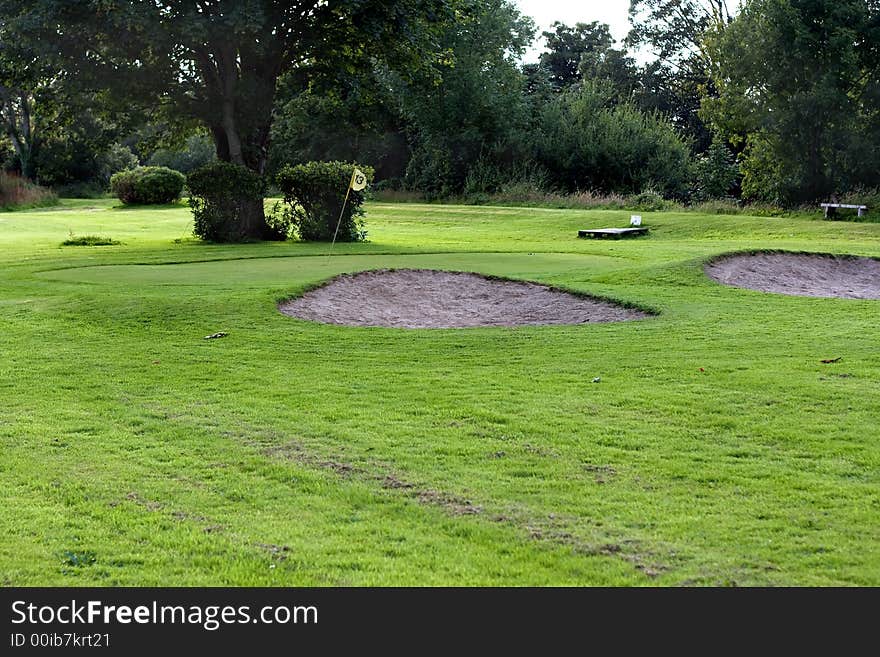 Golf field with yellow flag. Golf field with yellow flag.