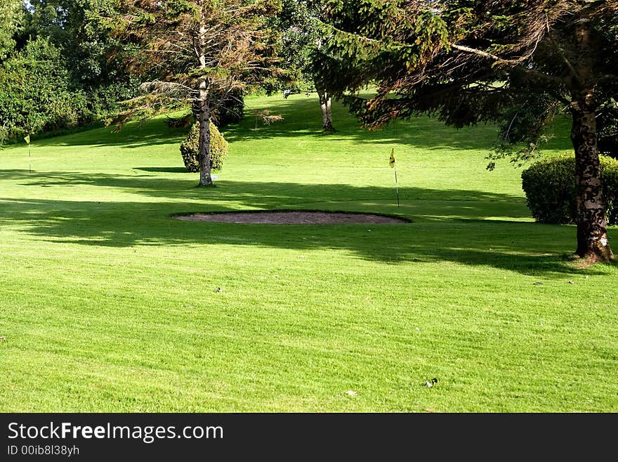 Golf field with yellow flag. Golf field with yellow flag.