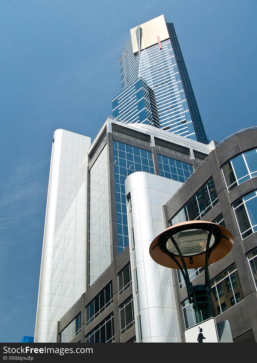 A collection of tall modern buildings looking skywards. Shot against a blue sky, with fine cloud. A collection of tall modern buildings looking skywards. Shot against a blue sky, with fine cloud