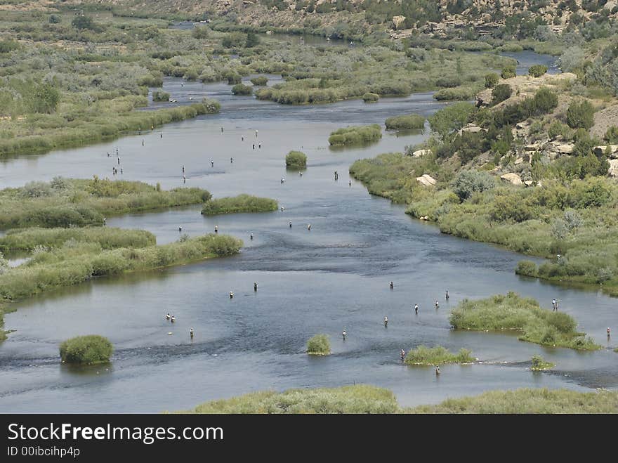 Fly fishers populate the qualtiy waters below the dam at the San Juan River Reservoir Northwestern New Mexico. Fly fishers populate the qualtiy waters below the dam at the San Juan River Reservoir Northwestern New Mexico.