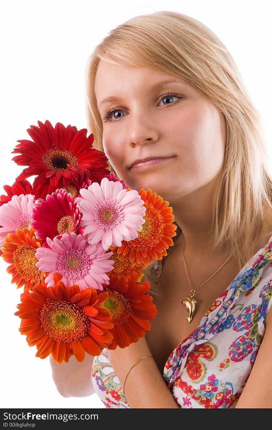 The beautiful blonde holds flowers in hands. The beautiful blonde holds flowers in hands