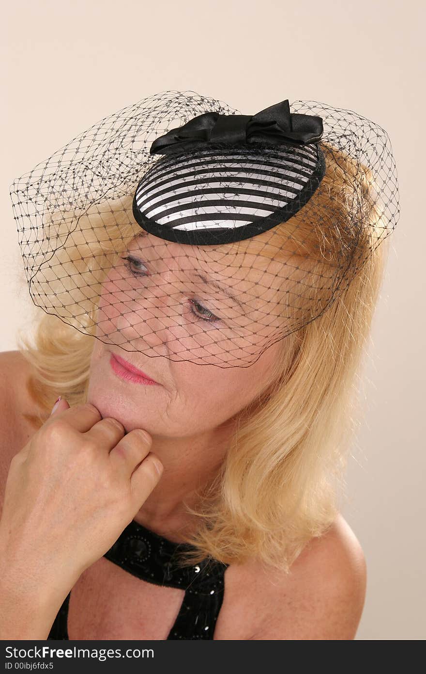 Elegant mature blond lady with small hat. Elegant mature blond lady with small hat