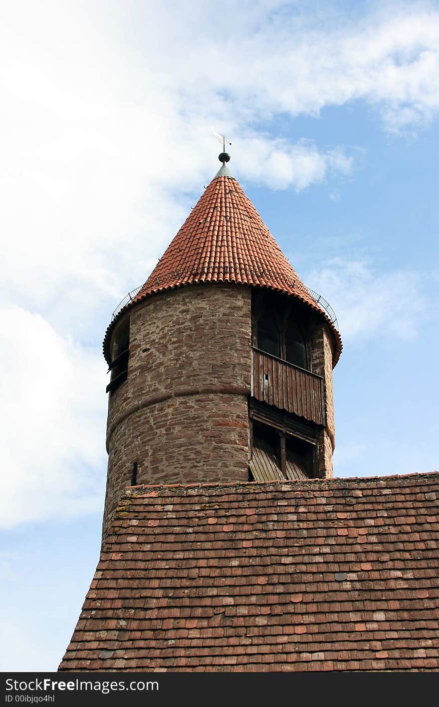 This image shows a medieval watchtower with clouds. This image shows a medieval watchtower with clouds