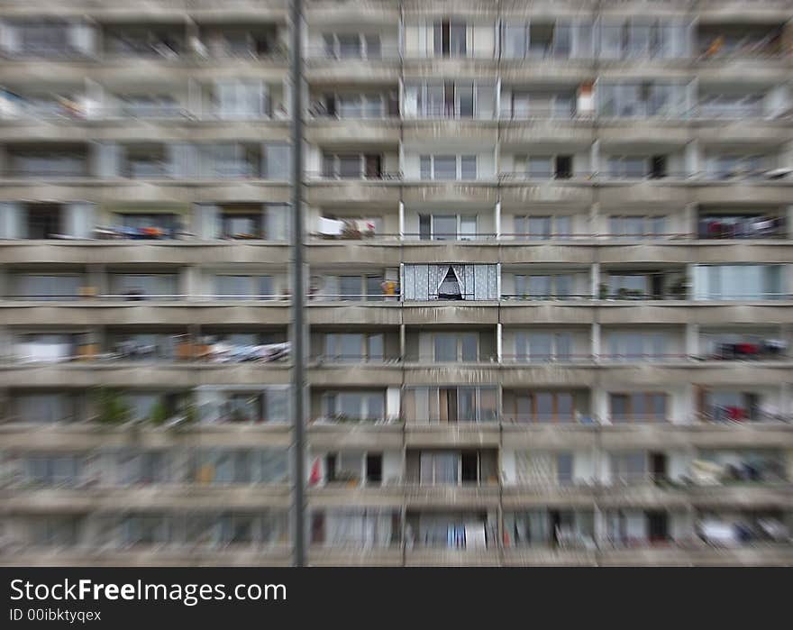 Depressive prefab house with cosy balcony highlighted by radial blur (zoom) effect. Socialist architecture, Petrzalka, Bratislava, Slovakia.