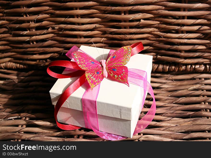 Gift box with a butterfly and ribbon used as decorations