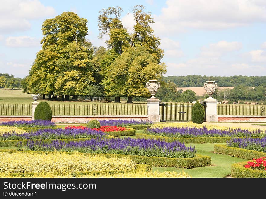 A enclosed garden with a never ending field and large trees