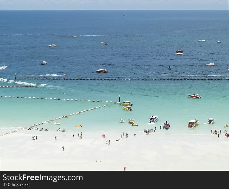 White, tropical beach and speedboats picking up passengers. White, tropical beach and speedboats picking up passengers