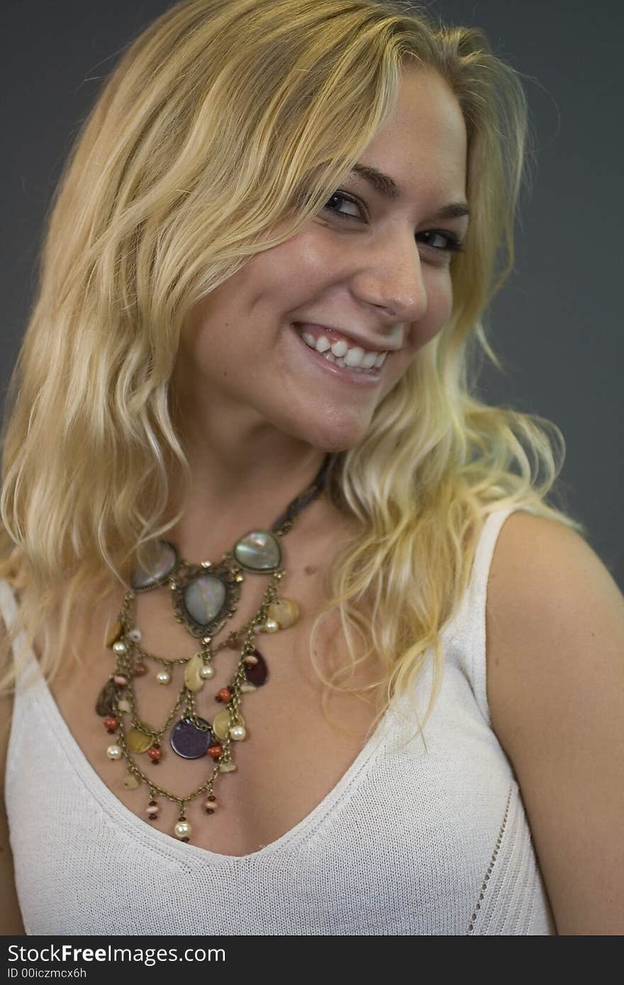 A young, vibrant woman having fun and smiling - facing towards the right. A young, vibrant woman having fun and smiling - facing towards the right