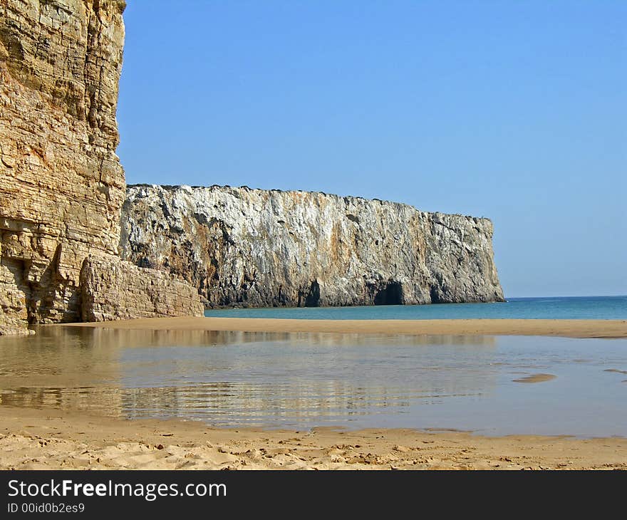 Pool of water reflecting off cliff with clear blue sky. Pool of water reflecting off cliff with clear blue sky