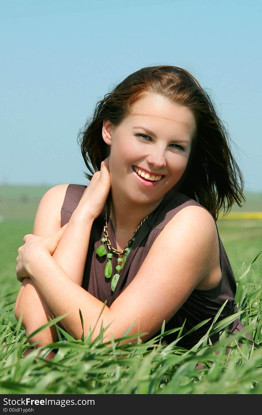 Beautiful and lively girl, in the green grass.