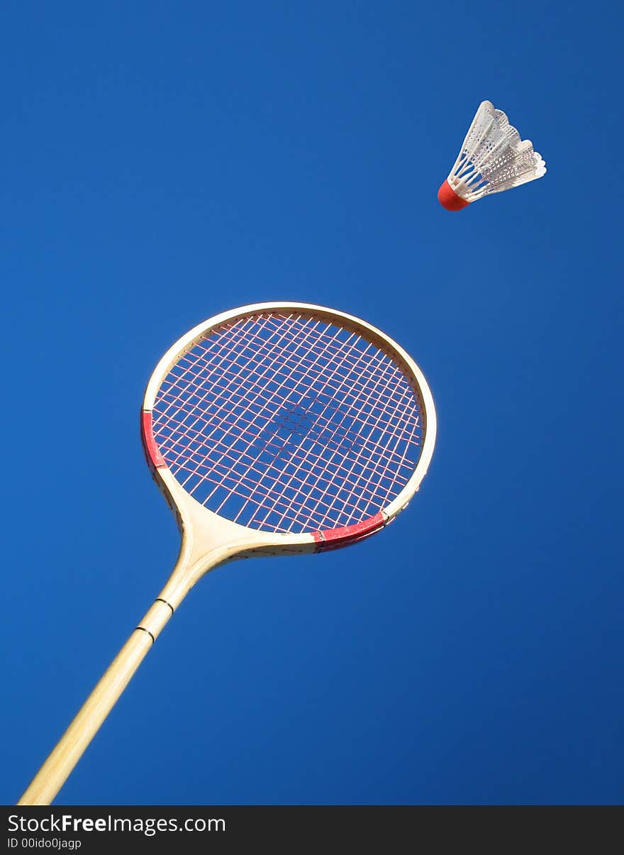 tennis racket with shuttlecock on blue background. tennis racket with shuttlecock on blue background