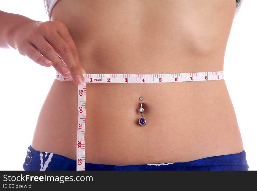 View of a girl measuring her waist. View of a girl measuring her waist