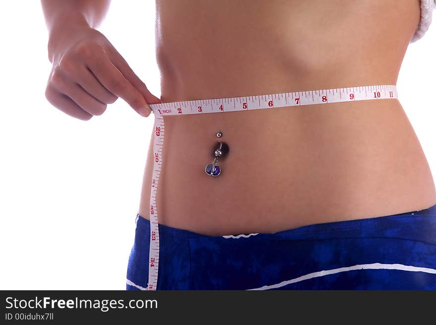 View of a girl measuring her waist. View of a girl measuring her waist