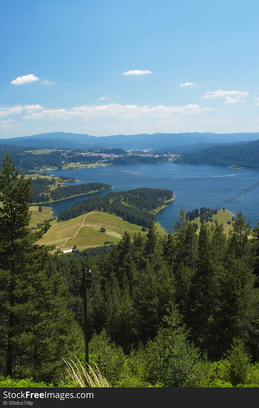 Summer mountain panorama with blue sky and lake. Summer mountain panorama with blue sky and lake