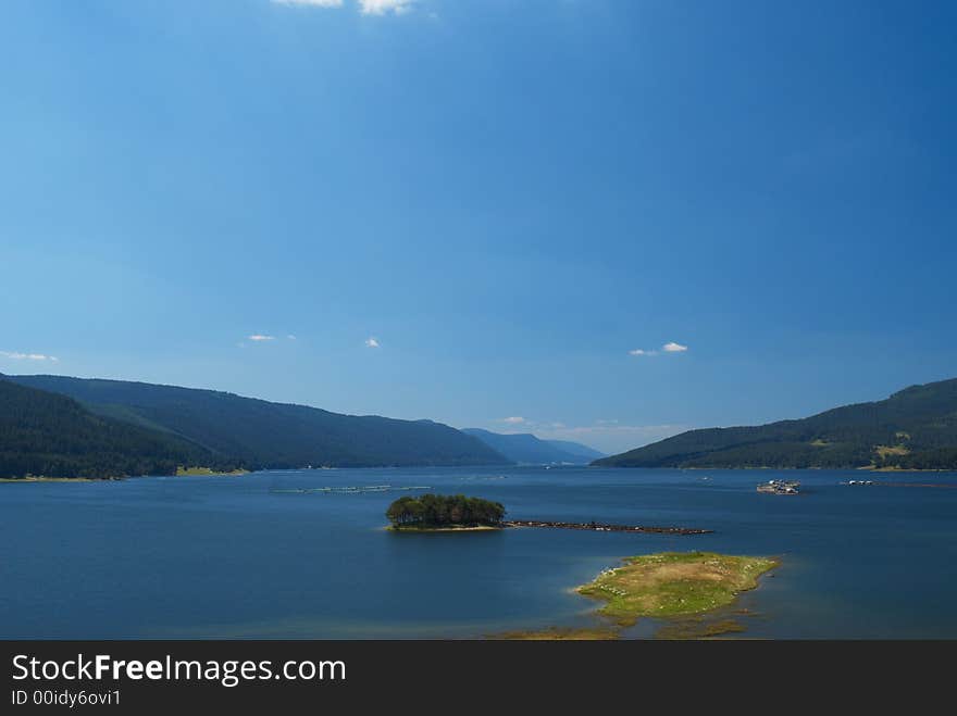 Summer mountain panorama with blue sky and lake. Summer mountain panorama with blue sky and lake