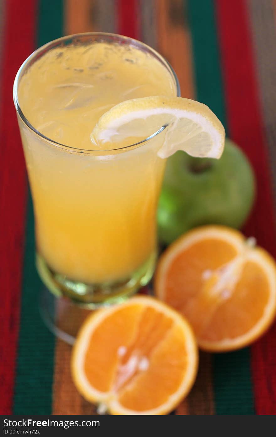 Orange and apple juice drink in a glass with ice