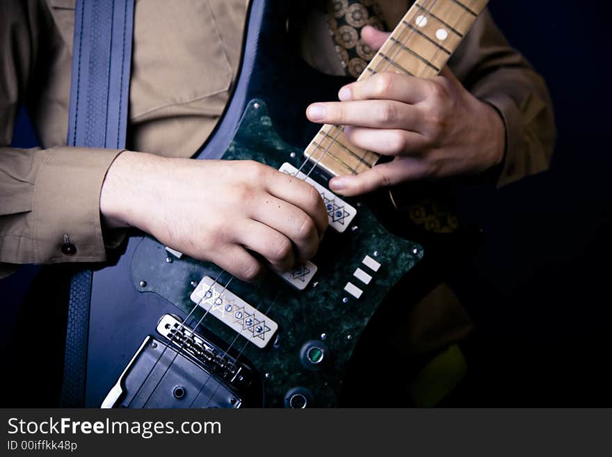 Guitarist hands on an electric guitar close up. Guitarist hands on an electric guitar close up.