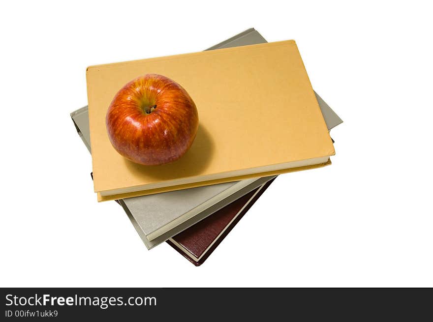 Several school books and an apple in front of and on white background. Several school books and an apple in front of and on white background