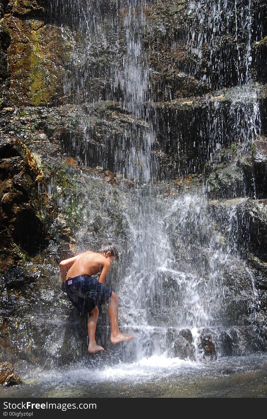 Boy Climbing The Waterfall