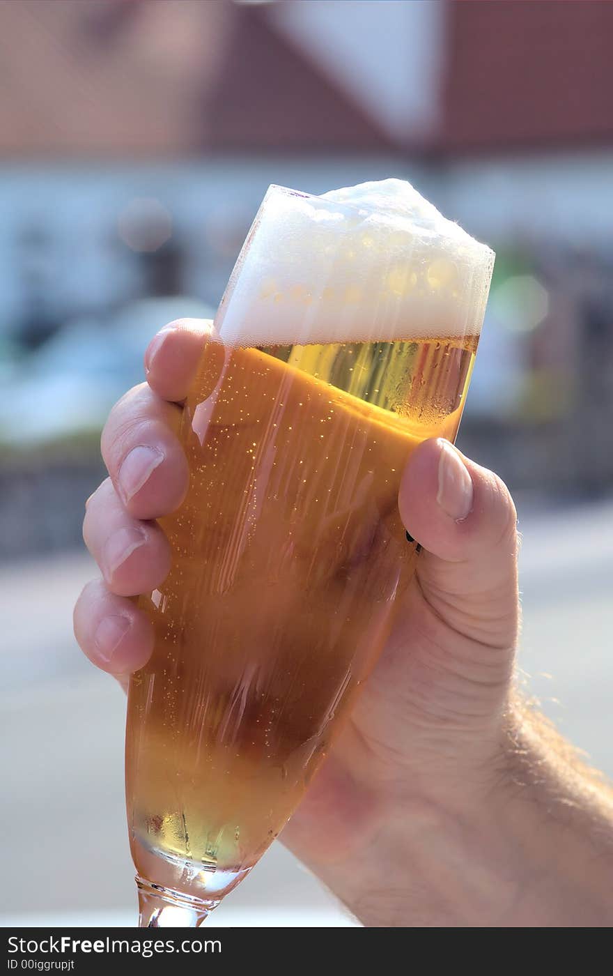 Hand holding a refreshing german lager