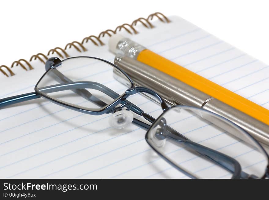 Eyeglasses on open notepad