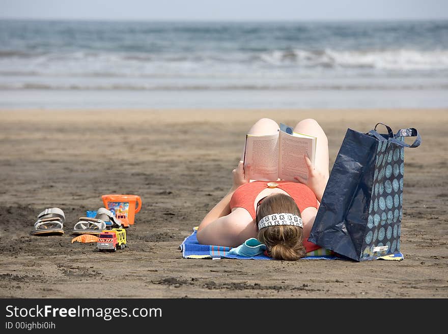 Woman reading on the beach. Woman reading on the beach