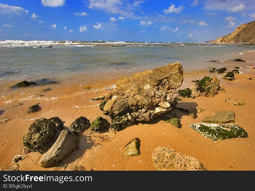 Coast of Mediterranean sea with big stones in water. Coast of Mediterranean sea with big stones in water