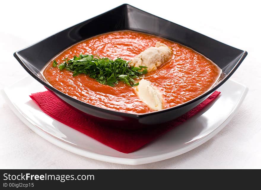 Tomato soup with chicken musse and green