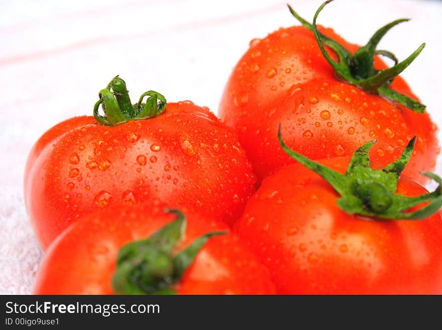 On a photo red tomatoes with drops of water