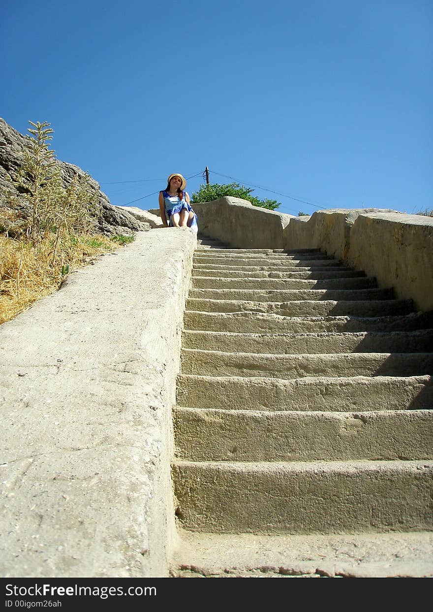 Girl is sitting on ancient staircase. Girl is sitting on ancient staircase