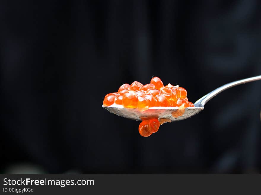 Red caviar in the spoon