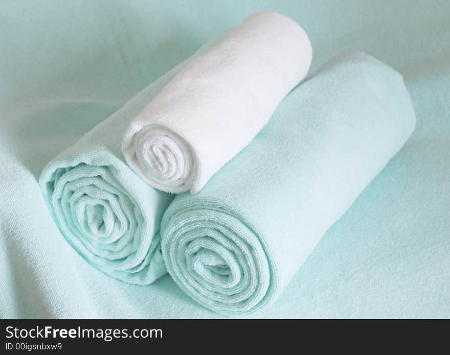 Light green towels rolled and ready to be used