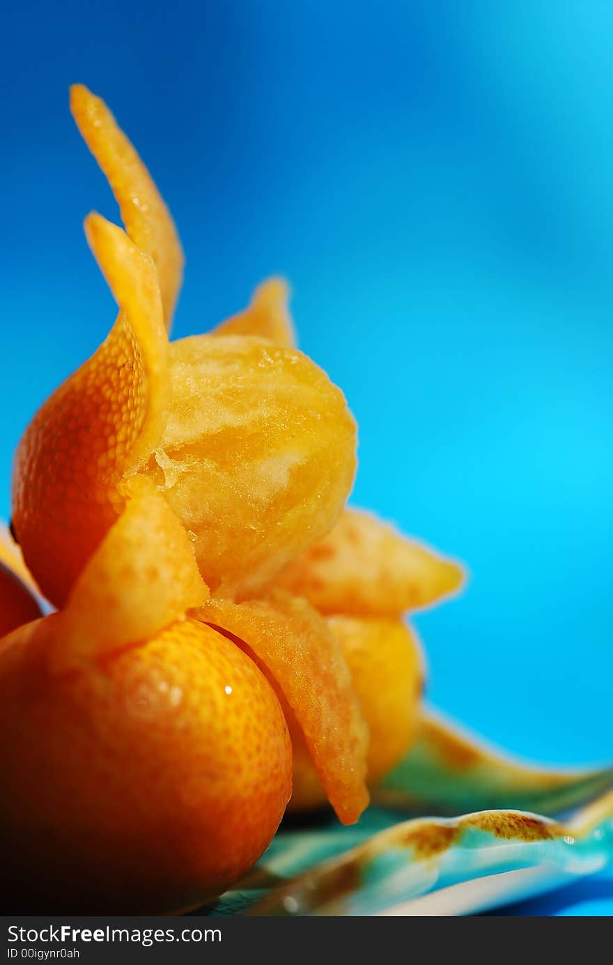 Delicious fresh citrus fruit on the blue plate.