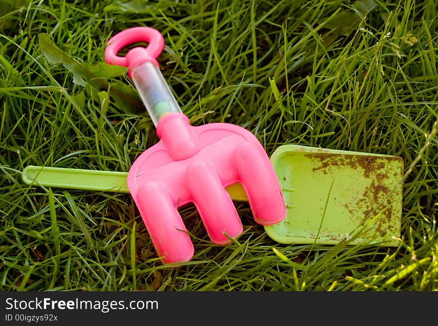 Rake and shovel in the grass