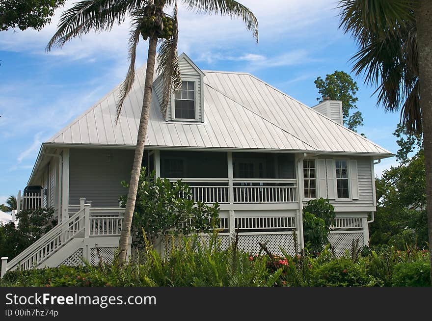 Tropical beach setting with a beautiful Florida style home. Tropical beach setting with a beautiful Florida style home