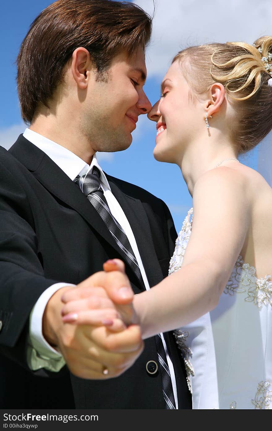 Bride looks at the fiance against the background of the sky