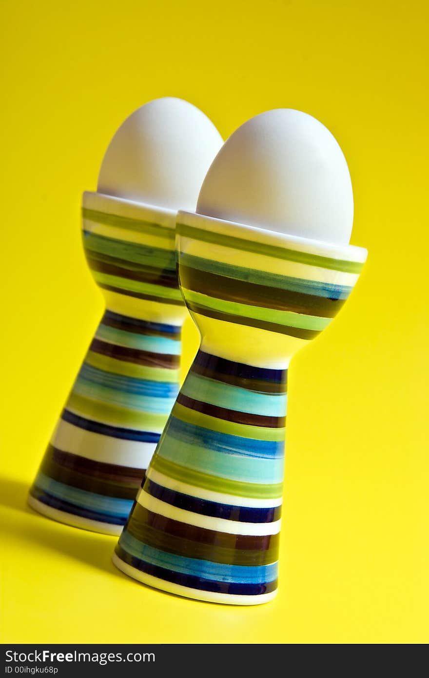 Boiled eggs in tall striped egg-cup