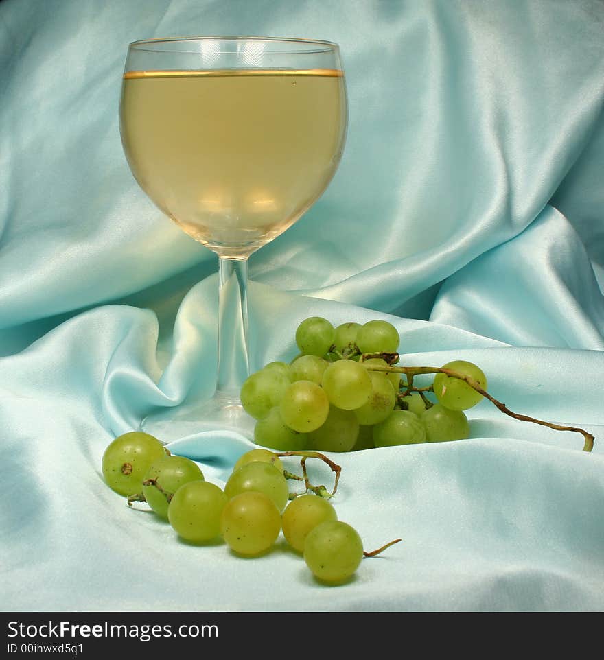 Glass white wine on blue backg