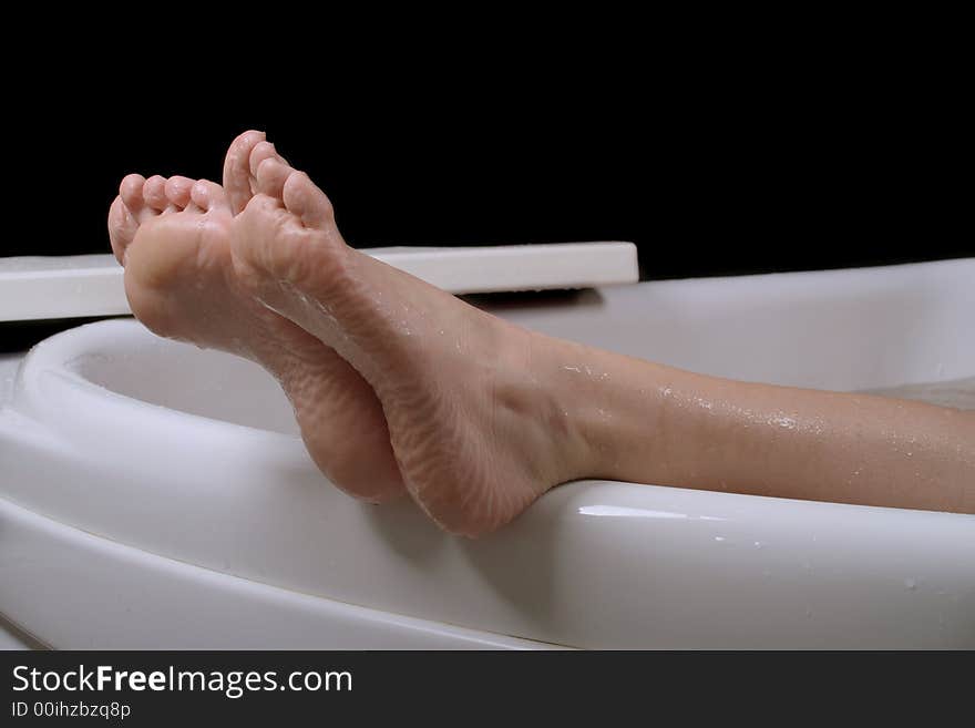 Beautiful female legs on the edge of bathtube