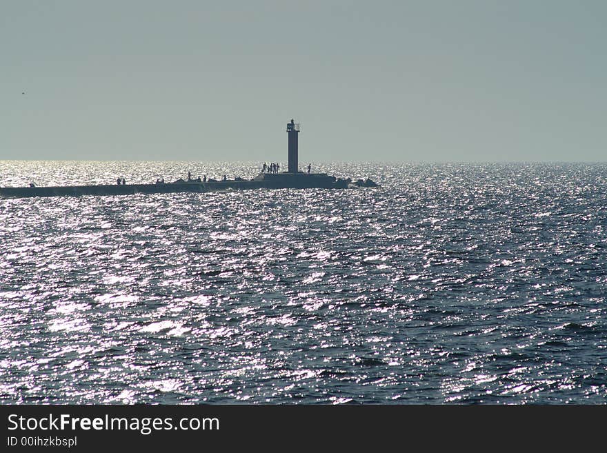 Lighthouse on pier in the sea