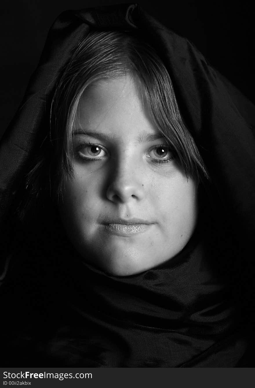 Dramatic portrait of a teen girl with her head wrapped.