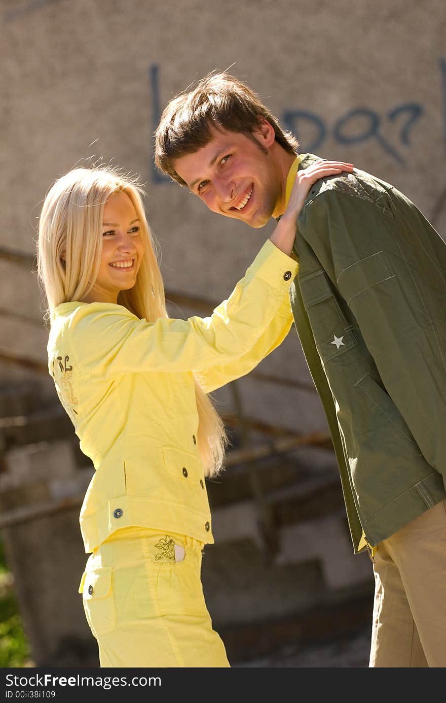 Cheerful young couple on the grunge background. Cheerful young couple on the grunge background